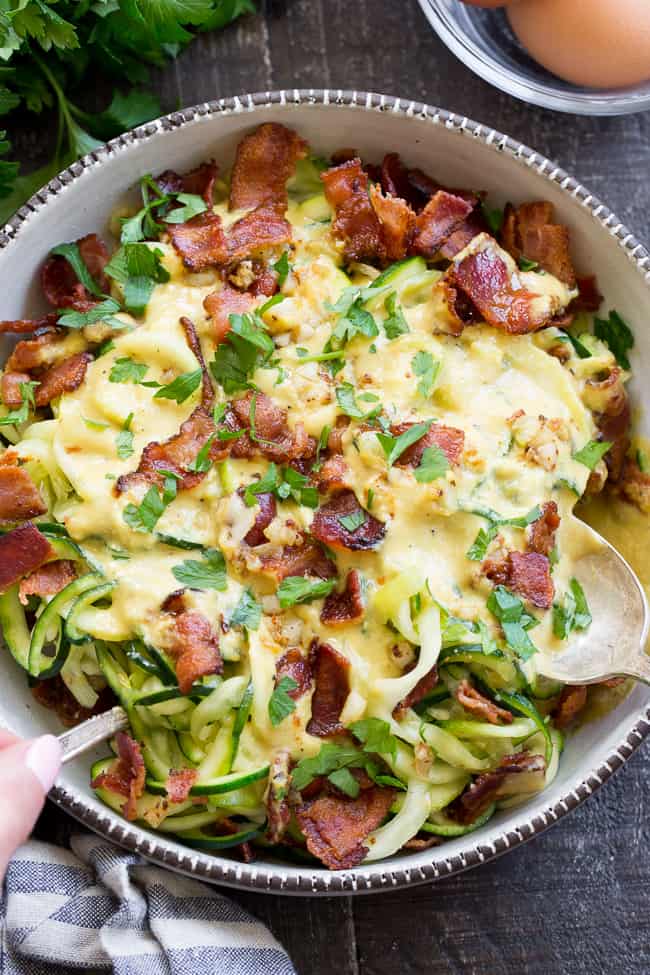 This paleo zucchini carbonara has a savory creamy sauce that you won't believe is dairy free!  Tossed with crisp bacon and low carb zucchini pasta, it's a healthy meal you'll want to make over and over again.  Paleo, Whole30 compliant, low carb, dairy free.