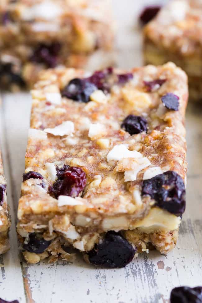 These no-bake grain free granola bars are loaded with sweet & tart dried cherries and berries, nuts, coconut and sweetened with dates to make them with no added sugar.  They're paleo, dairy-free, gluten-free, and perfect for healthy snacking anytime!