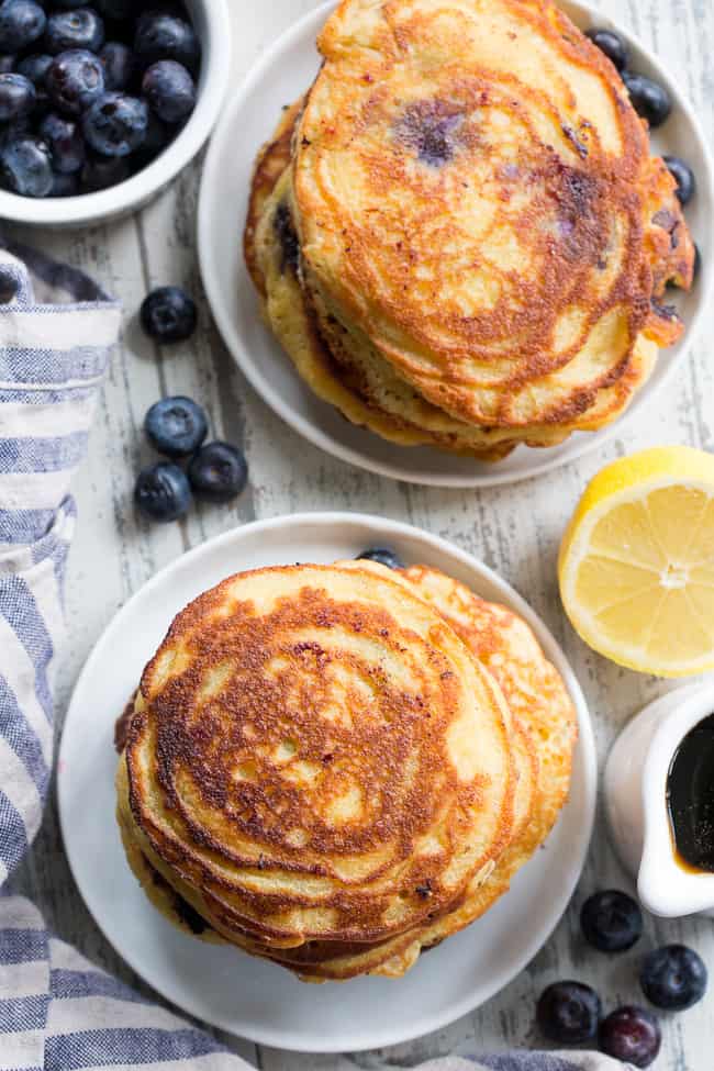 These paleo lemon blueberry pancakes are perfectly sweet and fluffy and a breeze to make!  They're packed with juicy blueberries and fresh lemon juice for a weekend breakfast or brunch that's healthy, delicious and even kid approved.  Gluten free, dairy free, grain free and refined-sugar free.