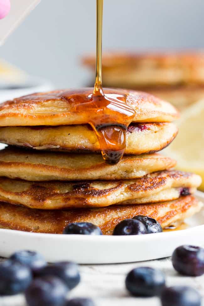 These paleo lemon blueberry pancakes are perfectly sweet and fluffy and a breeze to make!  They're packed with juicy blueberries and fresh lemon juice for a weekend breakfast or brunch that's healthy, delicious and even kid approved.  Gluten free, dairy free, grain free and refined-sugar free.