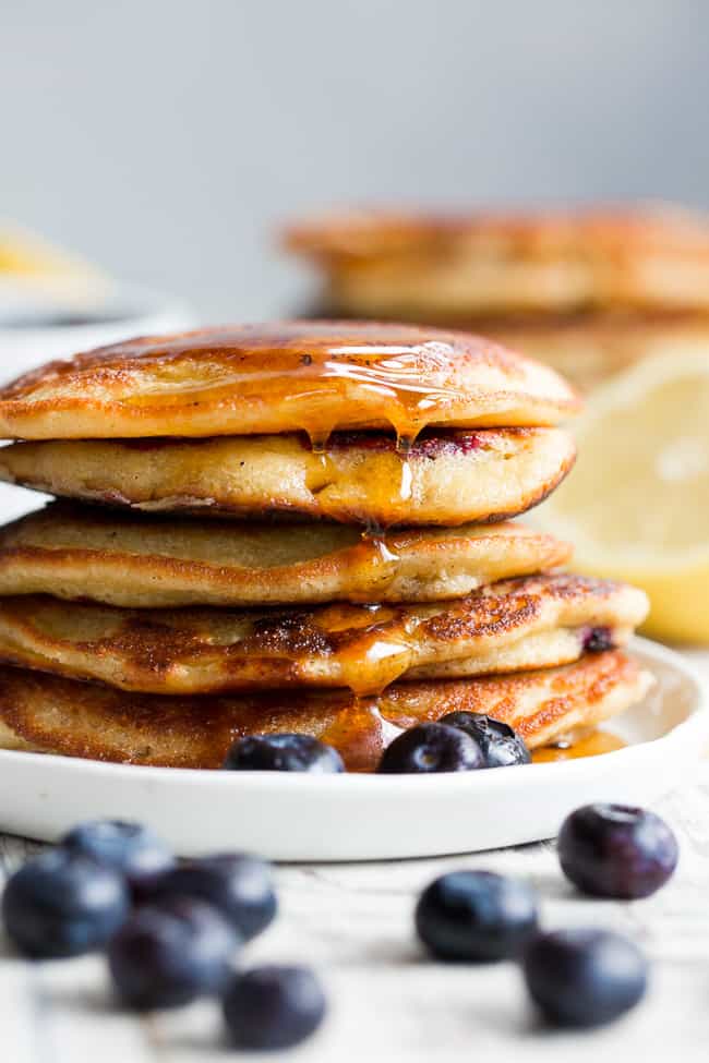 These paleo lemon blueberry pancakes are perfectly sweet and fluffy and a breeze to make!  They're packed with juicy blueberries and fresh lemon juice for a weekend breakfast or brunch that's healthy, delicious and even kid approved.  Gluten free, dairy free, grain free and refined-sugar free.