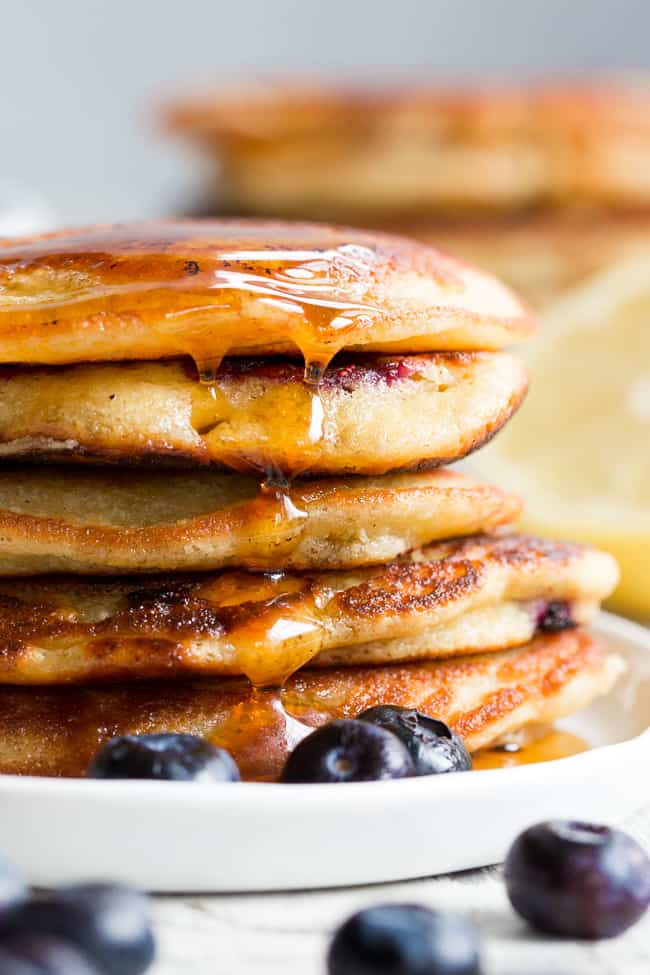 These paleo lemon blueberry pancakes are perfectly sweet and fluffy and a breeze to make!  They're packed with juicy blueberries and fresh lemon juice for a weekend breakfast or brunch that's healthy, delicious and even kid approved.  Gluten free, dairy free, grain free and refined-sugar free.