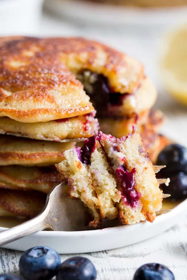 These paleo lemon blueberry pancakes are perfectly sweet and fluffy and a breeze to make!  They're packed with juicy blueberries and fresh lemon juice for a weekend breakfast or brunch that's healthy, delicious and even kid approved.  Gluten free, dairy free, grain free and refined-sugar free.