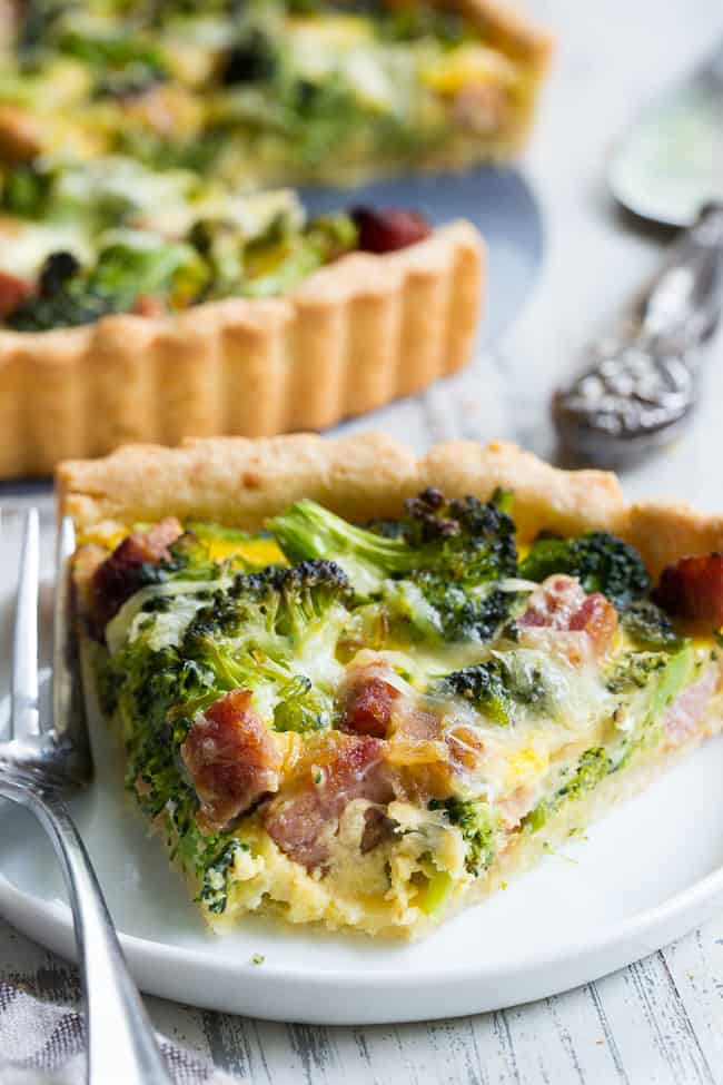 This grain free and paleo savory tart begins with the perfect paleo crust loaded with chopped broccoli and sugar-free ham, plus a creamy egg mixture with a dairy-free option.  This amazing savory tart is a family favorite, kid approved and perfect for brunch or as a make ahead breakfast!