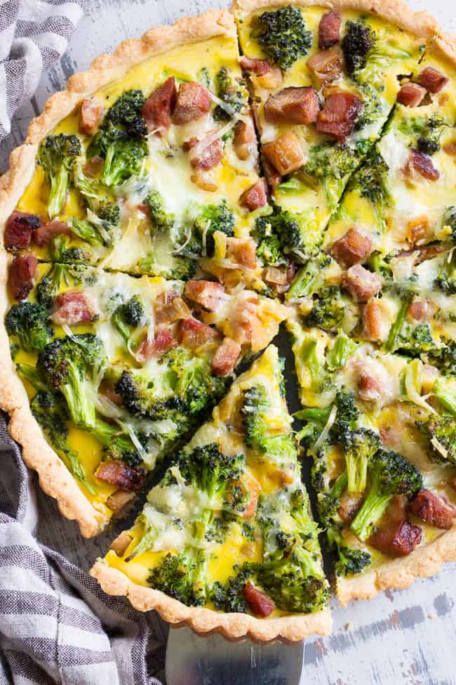 This grain free and paleo savory tart begins with the perfect paleo crust loaded with chopped broccoli and sugar-free ham, plus a creamy egg mixture with a dairy-free option.  This amazing savory tart is a family favorite, kid approved and perfect for brunch or as a make ahead breakfast!