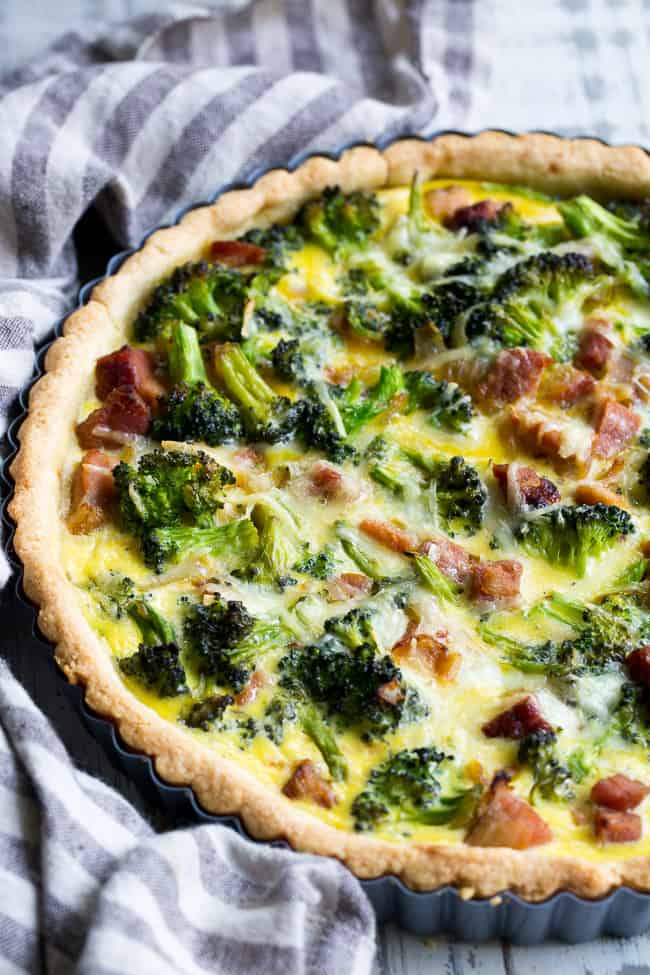 This grain free and paleo savory tart begins with the perfect paleo crust loaded with chopped broccoli and sugar-free ham, plus a creamy egg mixture with a dairy-free option.  This amazing savory tart is a family favorite, kid approved and perfect for brunch or as a make ahead breakfast!