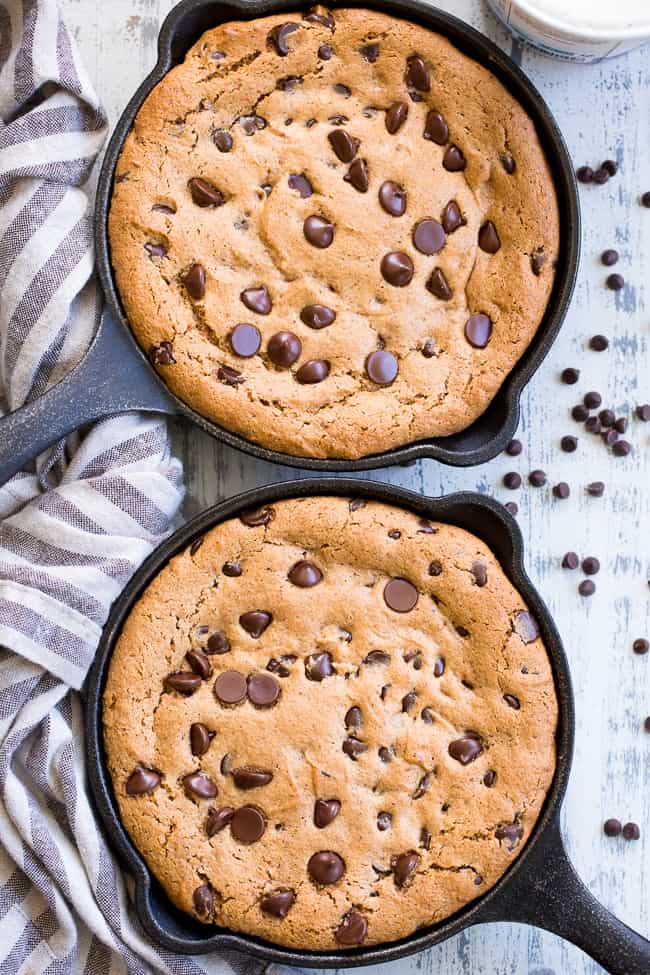 This fudgy paleo chocolate chip skillet cookie is loaded with good stuff!  Almond butter and coconut oil give it chewy moist and fudgy texture and it's sweetened with raw honey and unrefined coconut sugar.  A combination of coconut and arrowroot flour keep it grain free and gluten free!  It's packed with dark chocolate chips and perfect topped with a big scoop of coconut vanilla ice cream.