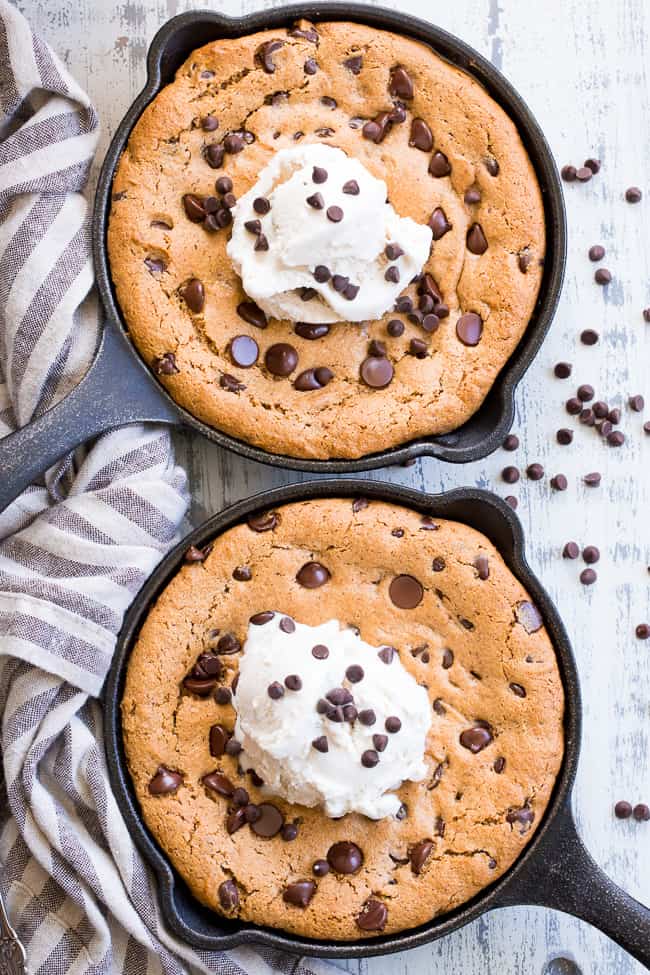 This fudgy paleo chocolate chip skillet cookie is loaded with good stuff!  Almond butter and coconut oil give it chewy moist and fudgy texture and it's sweetened with raw honey and unrefined coconut sugar.  A combination of coconut and arrowroot flour keep it grain free and gluten free!  It's packed with dark chocolate chips and perfect topped with a big scoop of coconut vanilla ice cream.