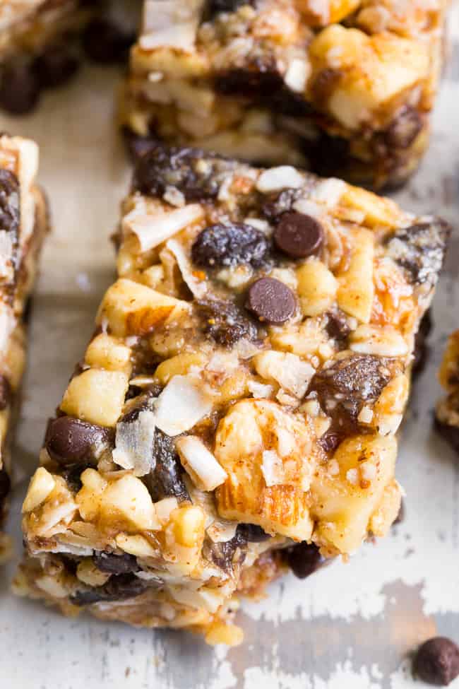 Chewy, crunchy, sweet and salty, these grain free and paleo no bake granola bars are going to become your favorite with the first bite!  They're loaded with raisins and mini chocolate chips, coconut flakes and nuts, sweetened with raw honey and packed with healthy fats.  Kid approved, gluten-free, dairy-free, grain free and addicting! 