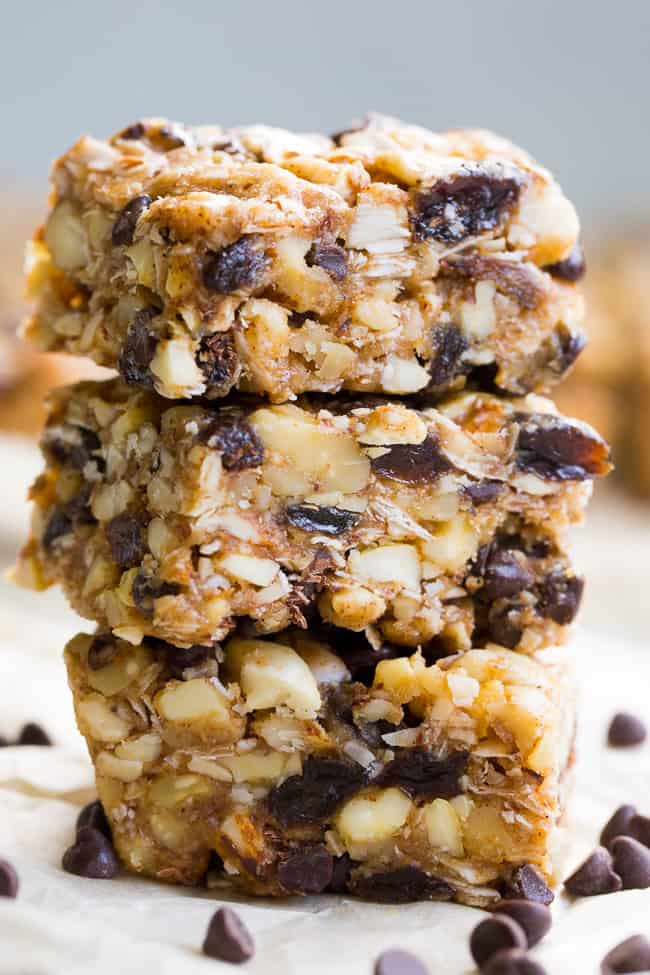 Chewy, crunchy, sweet and salty, these grain free and paleo no bake granola bars are going to become your favorite with the first bite!  They're loaded with raisins and mini chocolate chips, coconut flakes and nuts, sweetened with raw honey and packed with healthy fats.  Kid approved, gluten-free, dairy-free, grain free and addicting! 