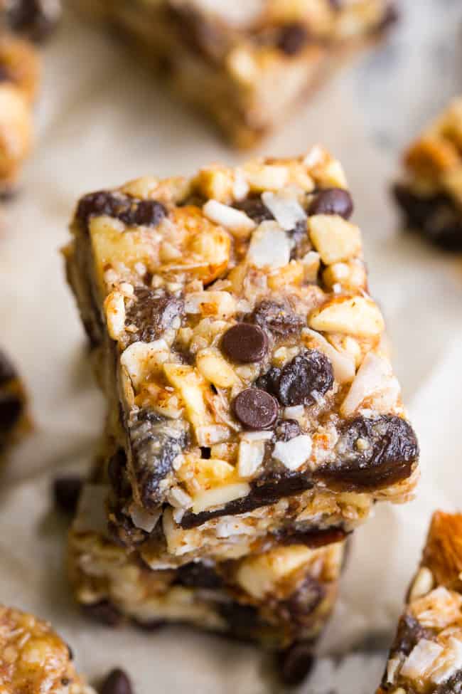 Chewy, crunchy, sweet and salty, these grain free and paleo no bake granola bars are going to become your favorite with the first bite!  They're loaded with raisins and mini chocolate chips, coconut flakes and nuts, sweetened with raw honey and packed with healthy fats.  Kid approved, gluten-free, dairy-free, grain free and addicting! 