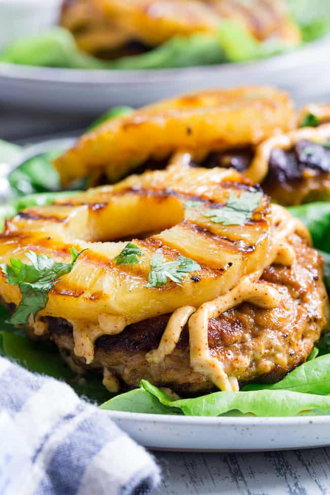 These spicy Hawaiian Chicken Burgers are super quick to make, packed with flavor and Whole30 compliant!  Serve in butter lettuce wraps topped with plenty of chipotle ranch for an easy weeknight dinner.  Perfect for grilling season or anytime!