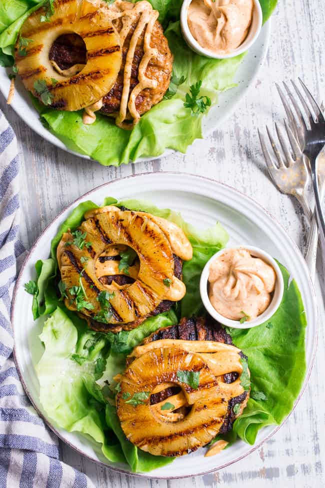 These spicy Hawaiian Chicken Burgers are super quick to make, packed with flavor and Whole30 compliant!  Serve in butter lettuce wraps topped with plenty of chipotle ranch for an easy weeknight dinner.  Perfect for grilling season or anytime!