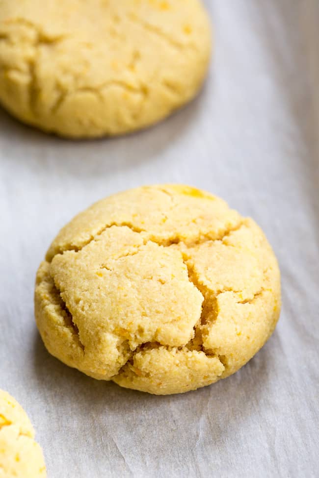 These paleo orange coconut cookies have a soft shortbread-like texture and tons of sweet citrus flavor!   They're made with coconut butter and coconut flour, so they're grain free, gluten free, dairy free and nut free.  These addicting cookies are kid approved and delicious with a coconut maple icing!