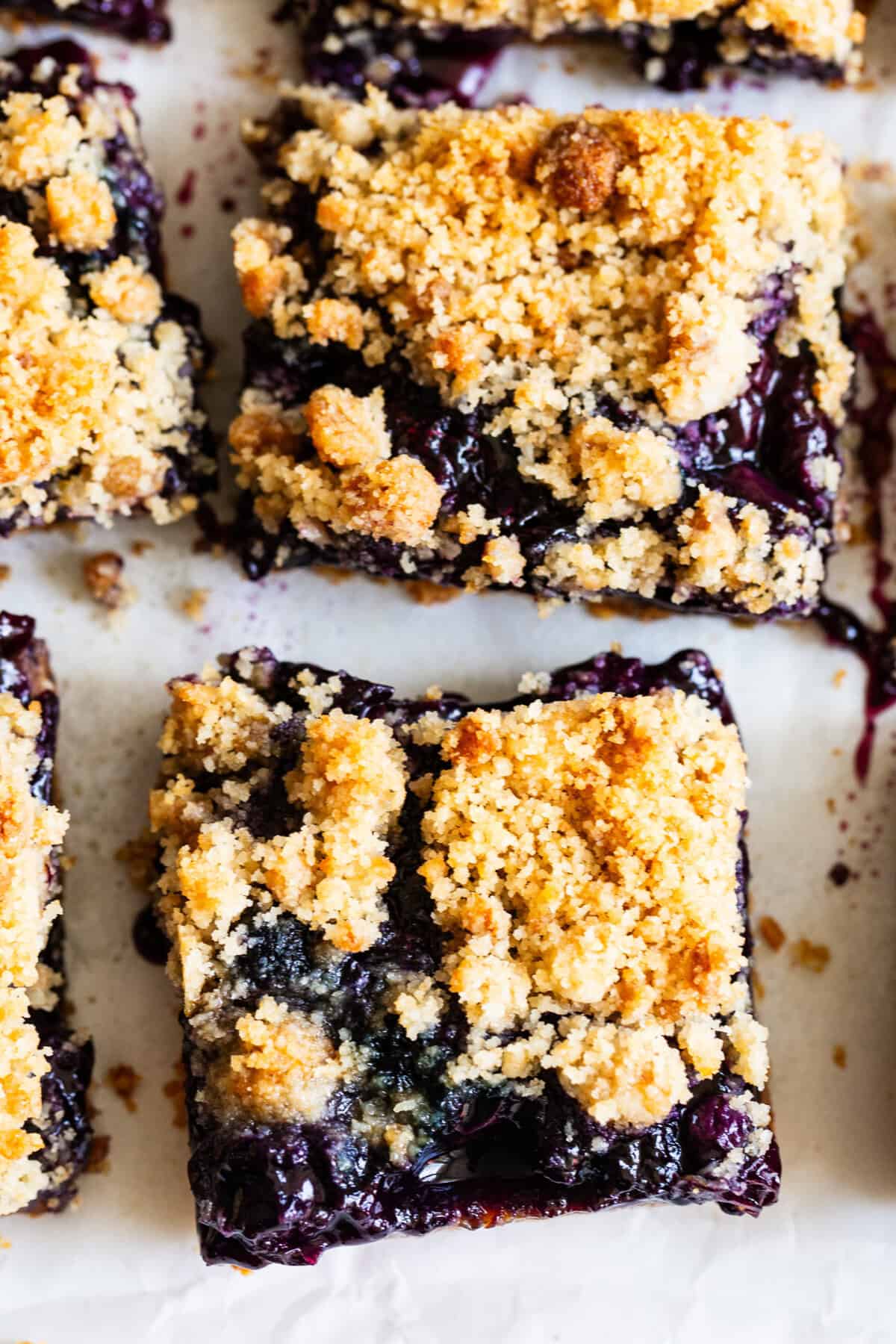 close up healthy blueberry crumble bars with almond flour crust and jammy filling