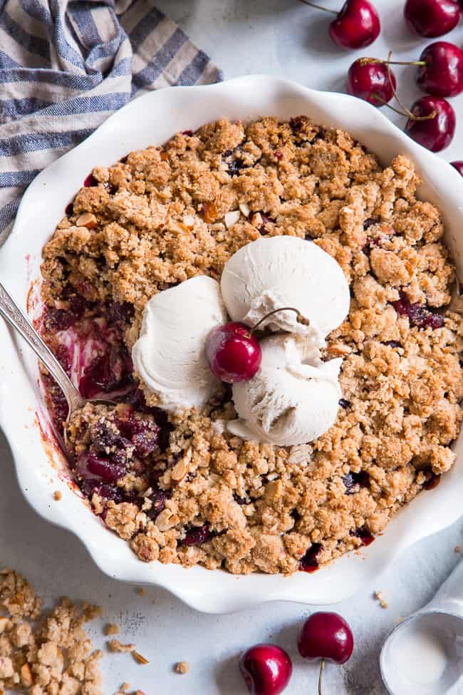 This classic cherry crisp is irresistibly delicious and easy to make!  A sweet gooey cherry filling is topped with a toasty crumble for a summer dessert that will make everyone come back for seconds.  It's paleo, vegan, gluten-free, dairy-free and refined sugar free.