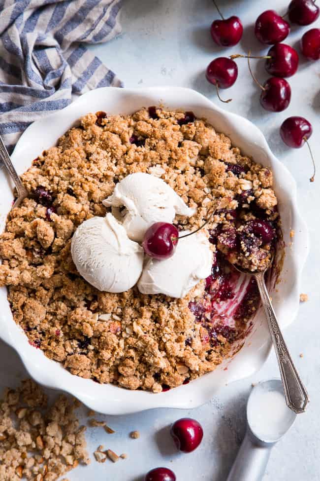 This classic cherry crisp is irresistibly delicious and easy to make!  A sweet gooey cherry filling is topped with a toasty crumble for a summer dessert that will make everyone come back for seconds.  It's paleo, vegan, gluten-free, dairy-free and refined sugar free.