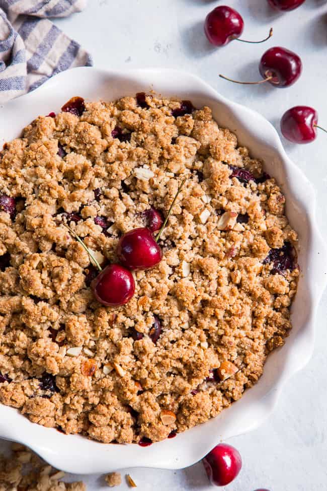 This classic cherry crisp is irresistibly delicious and easy to make!  A sweet gooey cherry filling is topped with a toasty crumble for a summer dessert that will make everyone come back for seconds.  It's paleo, vegan, gluten-free, dairy-free and refined sugar free.