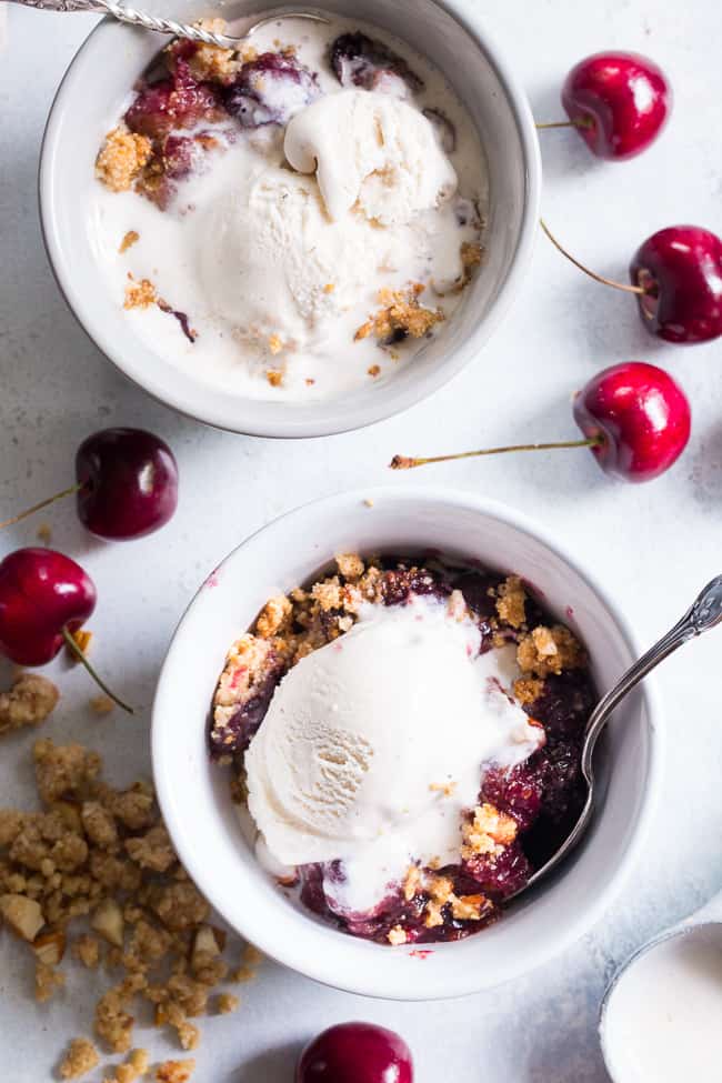 This classic cherry crisp is irresistibly delicious and easy to make!  A sweet gooey cherry filling is topped with a toasty crumble for a summer dessert that will make everyone come back for seconds.  It's paleo, vegan, gluten-free, dairy-free and refined sugar free.