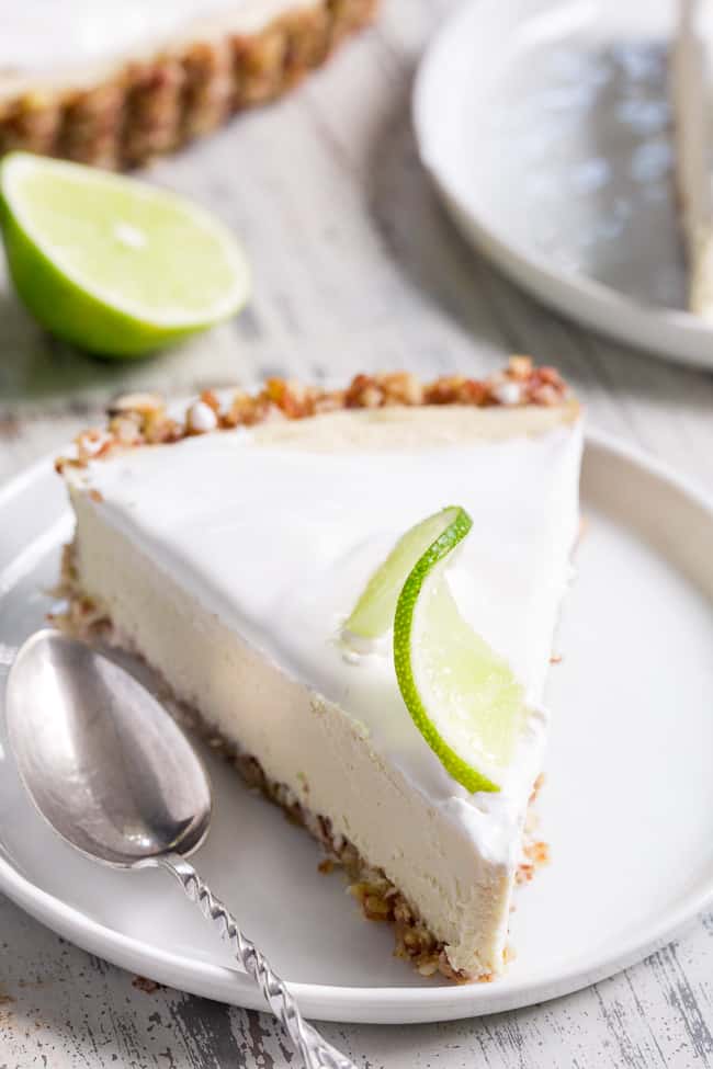This key lime paleo and vegan cheesecake tart is insanely creamy, perfectly sweet/tart and couldn't be easier to make!  The no-bake dairy-free, cashew-based filling blends up quickly and chills to perfection in a simple coconut pecan crust.   It's family approved and sure to become a favorite special occasion dessert!