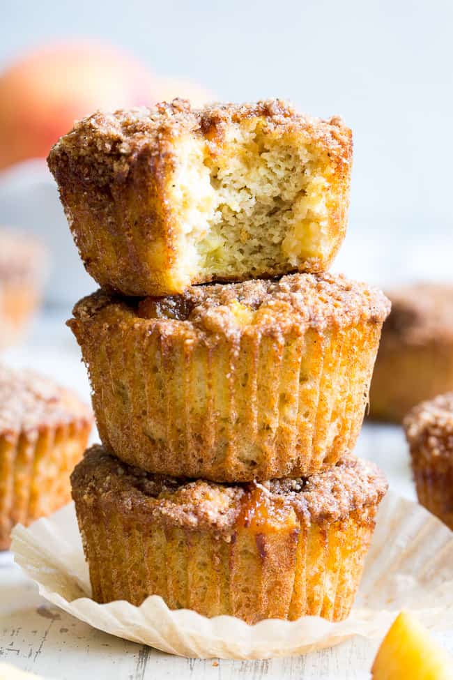 These Paleo peach muffins have double the peaches for tons of sweet summer flavor!  Easy peach preserves and chopped fresh peaches are mixed into a grain and dairy free muffin batter and topped with the perfect crumble.  Kid approved and great for summer snacking.