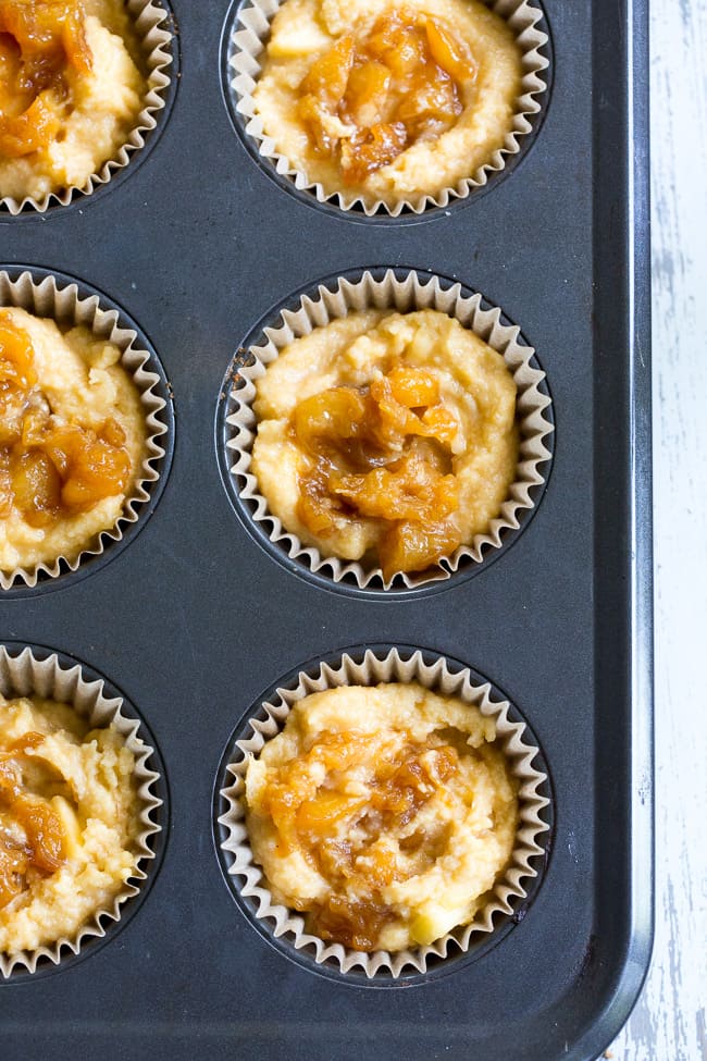 These Paleo peach muffins have double the peaches for tons of sweet summer flavor!  Easy peach preserves and chopped fresh peaches are mixed into a grain and dairy free muffin batter and topped with the perfect crumble.  Kid approved and great for summer snacking.