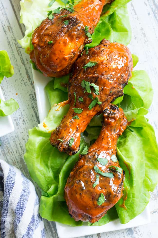 These spicy chicken drumsticks are perfectly seasoned, grilled, and tossed in a spicy, flavor-packed sauce!  Perfect for grilling season (or anytime of year!), family friendly, gluten-free, Paleo and Whole30 compliant. 