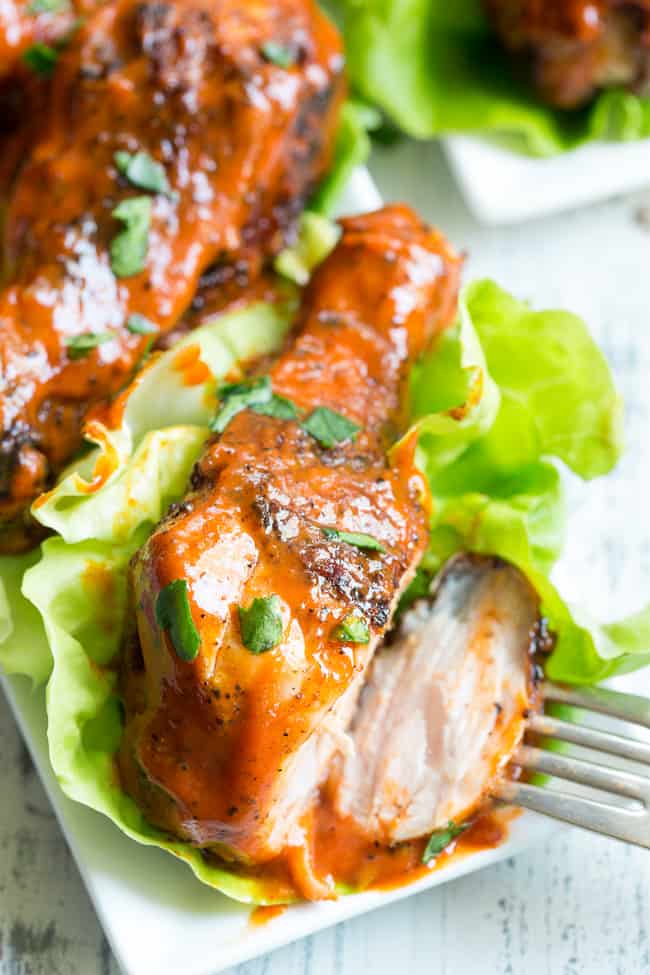 These spicy chicken drumsticks are perfectly seasoned, grilled, and tossed in a spicy, flavor-packed sauce!  Perfect for grilling season (or anytime of year!), family friendly, gluten-free, Paleo and Whole30 compliant. 