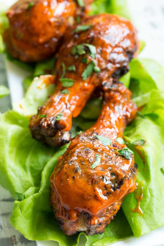 These spicy chicken drumsticks are perfectly seasoned, grilled, and tossed in a spicy, flavor-packed sauce!  Perfect for grilling season (or anytime of year!), family friendly, gluten-free, Paleo and Whole30 compliant. 