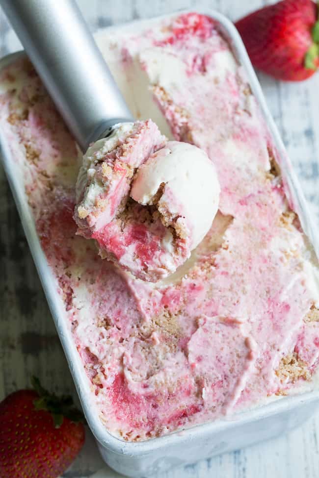 This Strawberry Cheesecake Paleo + Vegan Ice Cream begins with a cashew-based, creamy "cheesecake" ice cream and swirls in strawberry puree and a grain-free graham cracker crust!  It's the perfect special treat for summer that no one will guess is actually gluten-free, dairy free, paleo and vegan!