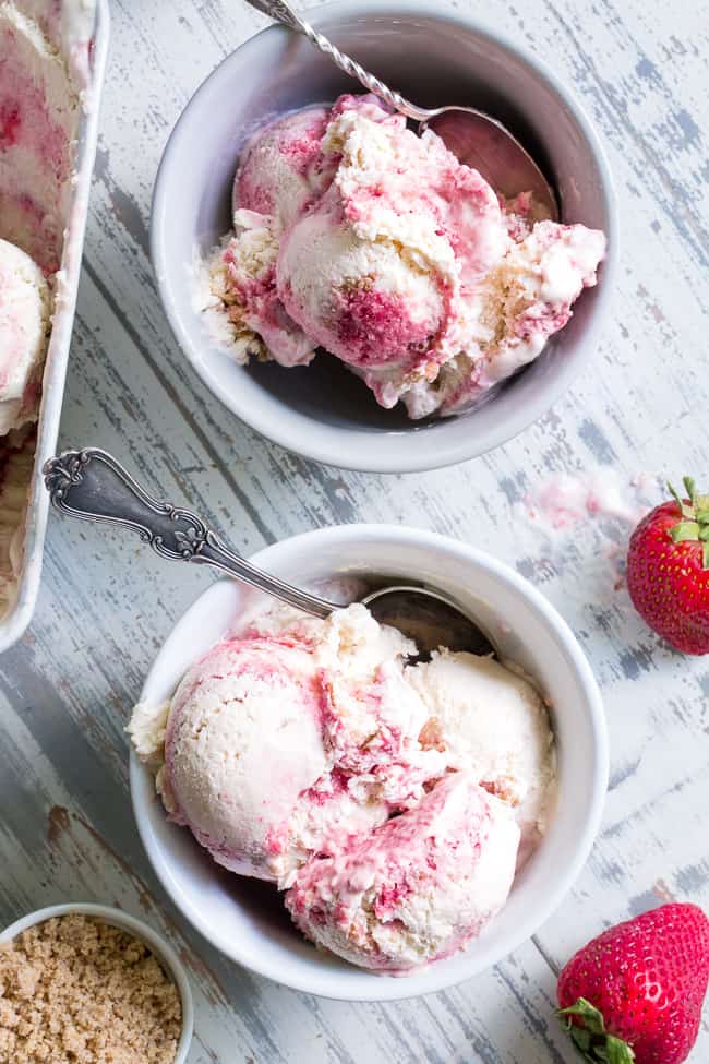 This Strawberry Cheesecake Paleo + Vegan Ice Cream begins with a cashew-based, creamy "cheesecake" ice cream and swirls in strawberry puree and a grain-free graham cracker crust!  It's the perfect special treat for summer that no one will guess is actually gluten-free, dairy free, paleo and vegan!