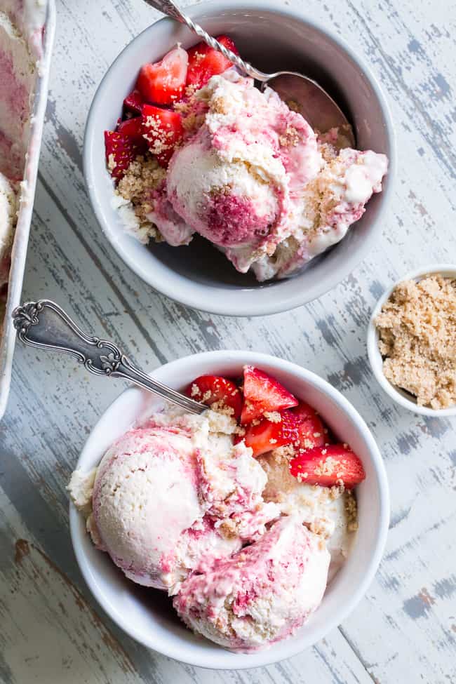 This Strawberry Cheesecake Paleo + Vegan Ice Cream begins with a cashew-based, creamy "cheesecake" ice cream and swirls in strawberry puree and a grain-free graham cracker crust!  It's the perfect special treat for summer that no one will guess is actually gluten-free, dairy free, paleo and vegan!