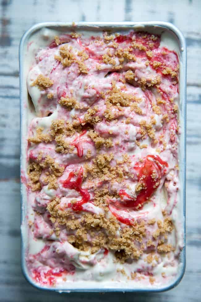 This Strawberry Cheesecake Paleo + Vegan Ice Cream begins with a cashew-based, creamy "cheesecake" ice cream and swirls in strawberry puree and a grain-free graham cracker crust!  It's the perfect special treat for summer that no one will guess is actually gluten-free, dairy free, paleo and vegan!