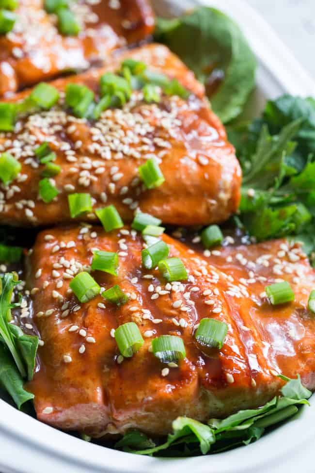 This Paleo and Whole30 Grilled Teriyaki Salmon is incredibly easy and busting out with flavor!  A simple date-sweetened teriyaki sauce is drizzled all over perfectly grilled salmon fillets and topped with toasted sesame seeds and scallions.  Perfect over a green salad or cauliflower rice!