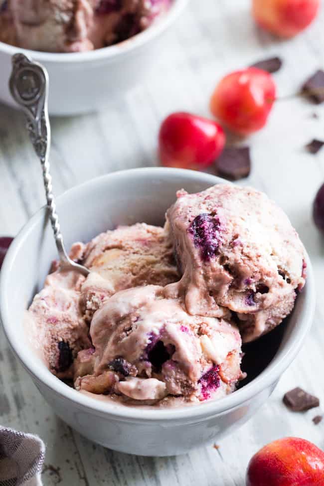 This cherry fudge swirl ice cream is made healthier, paleo, and vegan with coconut milk and pure maple sugar.  It's rich and creamy with a dreamy chocolate fudge swirl and lots of chopped fresh cherries in every bite.  Egg free, vegan, dairy free, refined sugar free and absolutely irresistible!