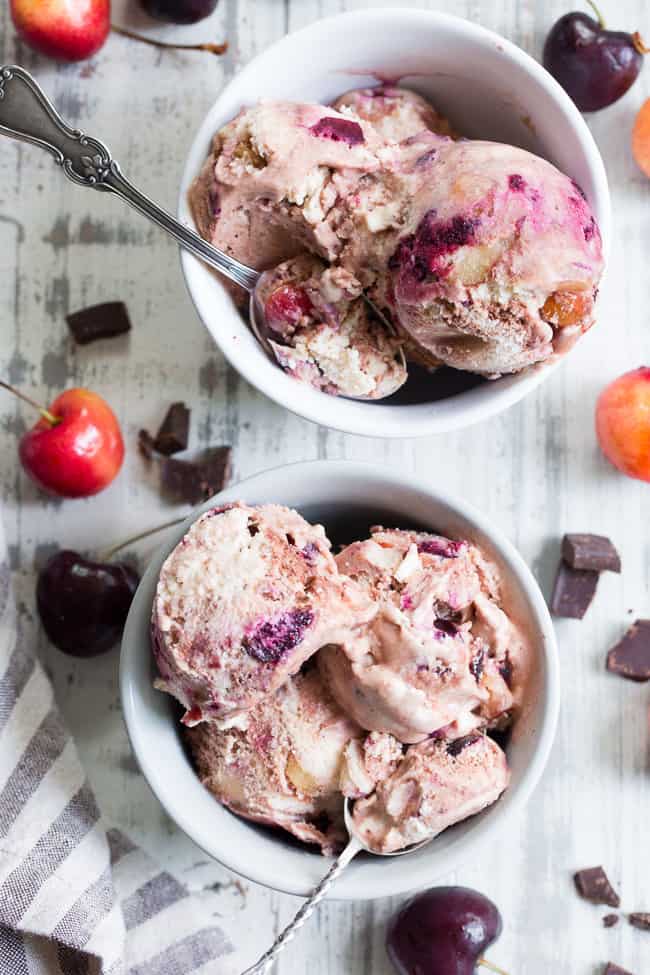 This cherry fudge swirl ice cream is made healthier, paleo, and vegan with coconut milk and pure maple sugar.  It's rich and creamy with a dreamy chocolate fudge swirl and lots of chopped fresh cherries in every bite.  Egg free, vegan, dairy free, refined sugar free and absolutely irresistible!