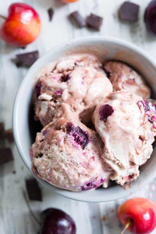 This cherry fudge swirl ice cream is made healthier, paleo, and vegan with coconut milk and pure maple sugar.  It's rich and creamy with a dreamy chocolate fudge swirl and lots of chopped fresh cherries in every bite.  Egg free, vegan, dairy free, refined sugar free and absolutely irresistible!