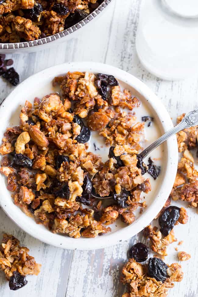 This crunchy paleo granola is loaded with goodies and so incredibly tasty!   Grain free granola clusters are baked with maple and tossed with sweet and tart dried cherries and dark chocolate chips.  It makes the perfect sweet snack or breakfast that everyone will love!  Gluten free, vegan, paleo.