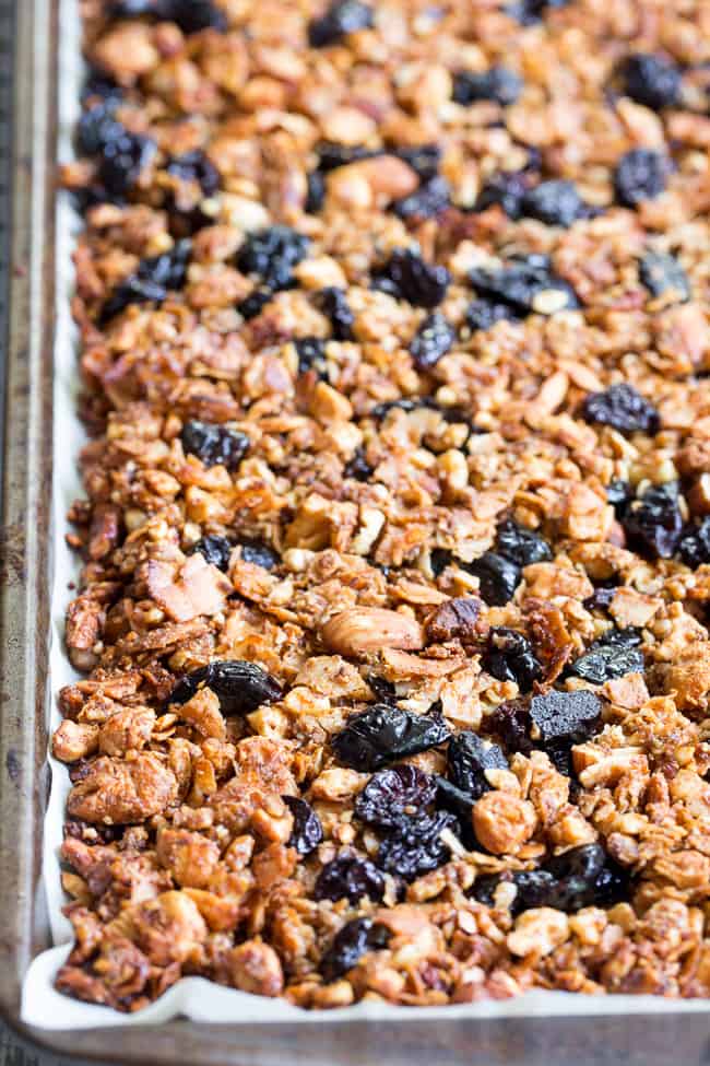 This crunchy paleo granola is loaded with goodies and so incredibly tasty!   Grain free granola clusters are baked with maple and tossed with sweet and tart dried cherries and dark chocolate chips.  It makes the perfect sweet snack or breakfast that everyone will love!  Gluten free, vegan, paleo.