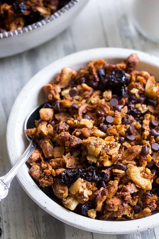 This crunchy paleo granola is loaded with goodies and so incredibly tasty!   Grain free granola clusters are baked with maple and tossed with sweet and tart dried cherries and dark chocolate chips.  It makes the perfect sweet snack or breakfast that everyone will love!  Gluten free, vegan, paleo.