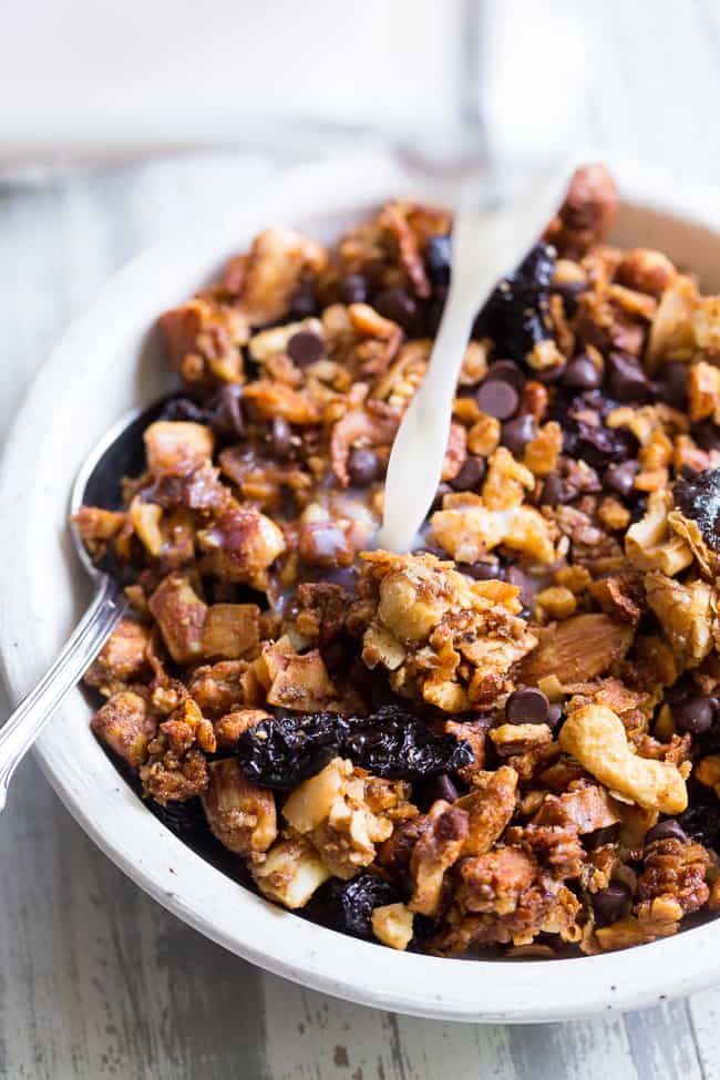 This crunchy paleo granola is loaded with goodies and so incredibly tasty!   Grain free granola clusters are baked with maple and tossed with sweet and tart dried cherries and dark chocolate chips.  It makes the perfect sweet snack or breakfast that everyone will love!  Gluten free, vegan, paleo.