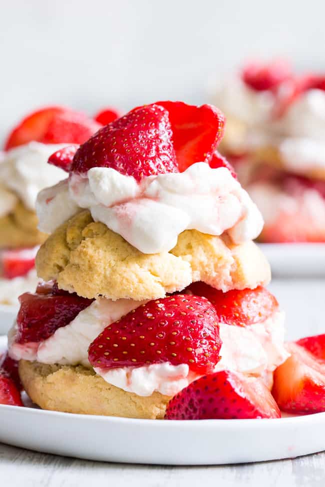 Classic strawberry shortcake is made gluten-free, dairy-free, and paleo yet it's every bit as delicious as the original!  Grain free Paleo biscuits are filled with lightly sweetened strawberries and an easy coconut whipped cream for a fun anytime dessert that everyone will love. 