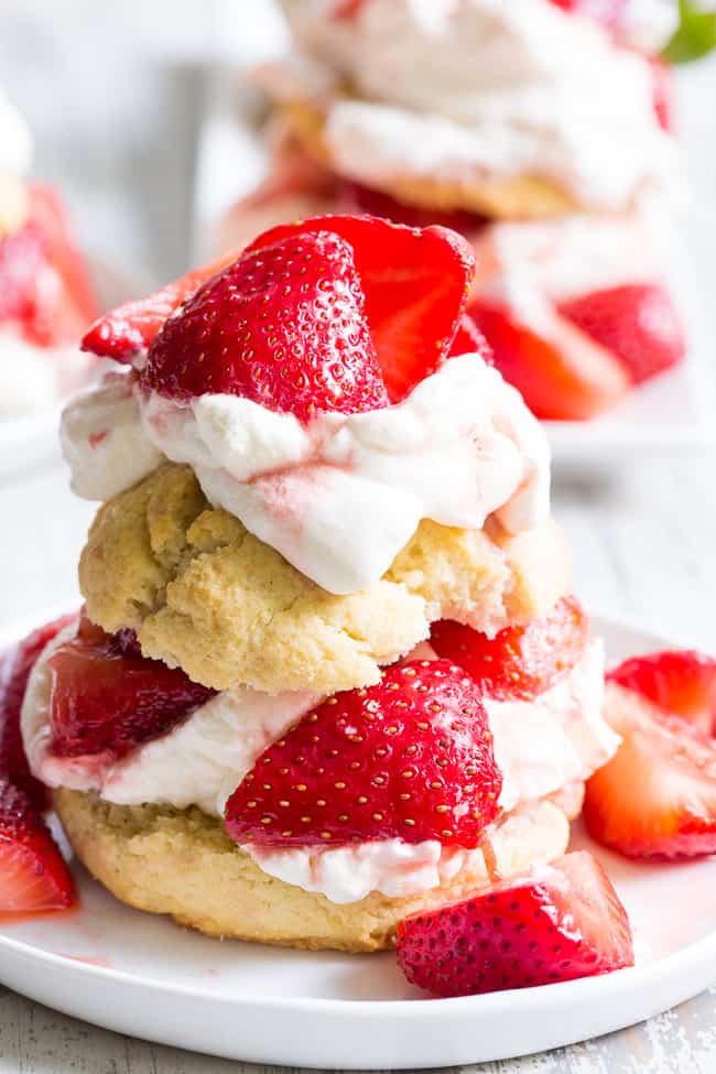 Classic strawberry shortcake is made gluten-free, dairy-free, and paleo yet it's every bit as delicious as the original!  Grain free Paleo biscuits are filled with lightly sweetened strawberries and an easy coconut whipped cream for a fun anytime dessert that everyone will love. 