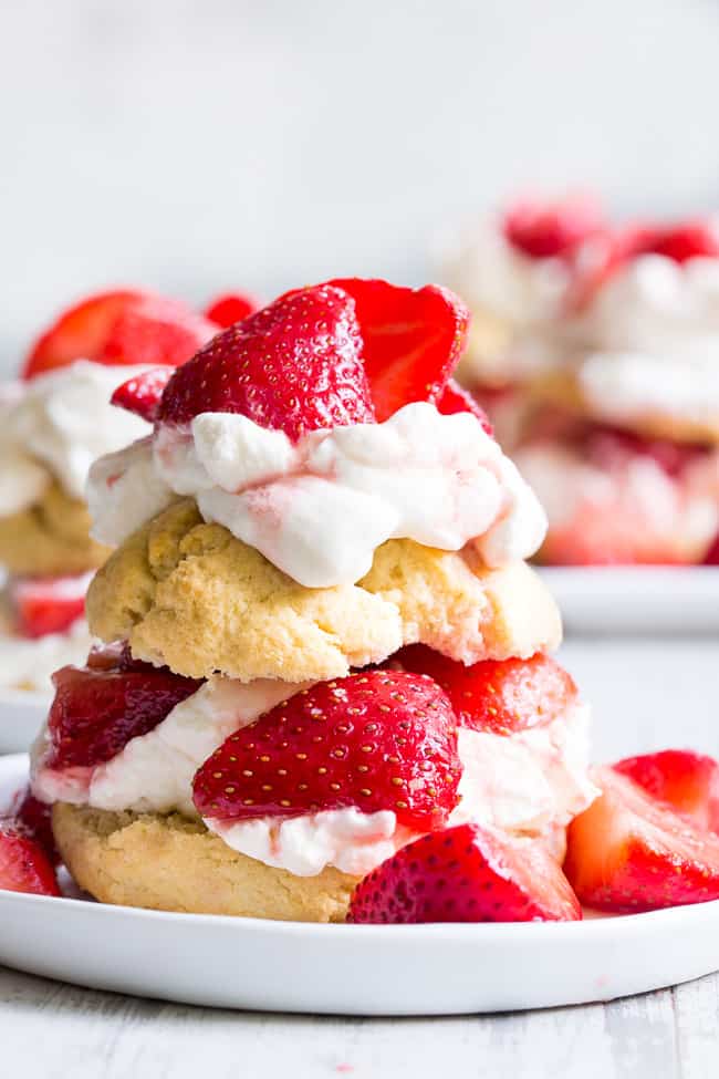 Classic strawberry shortcake is made gluten-free, dairy-free, and paleo yet it's every bit as delicious as the original!  Grain free Paleo biscuits are filled with lightly sweetened strawberries and an easy coconut whipped cream for a fun anytime dessert that everyone will love. 