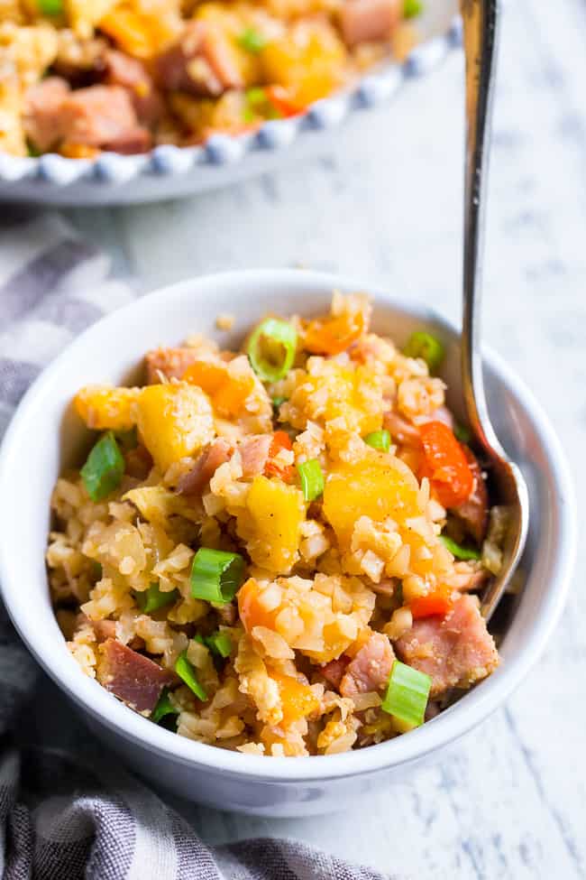 This Hawaiian Cauliflower Fried Rice is packed with goodies and so simple to make!  Chopped pineapples and sugar-free ham, peppers, onions and scrambled eggs make this "rice" a meal that you'll crave for busy weeknights.   It's also kid approved, low in carbs and Whole30 compliant!