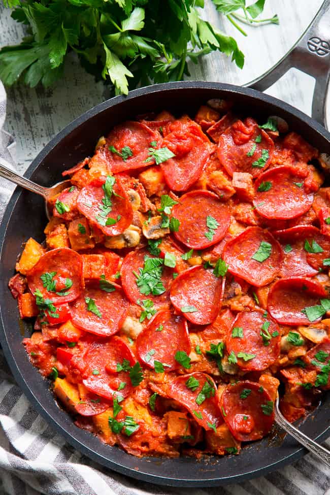 This sweet potato skillet is loaded up with all your favorite goodies just like a pepperoni pizza!  Pan-fried sweet potatoes with peppers, onions, mushrooms, pepperoni and pizza sauce make this paleo, gluten-free, dairy-free skillet quick, easy, and absolutely delicious!