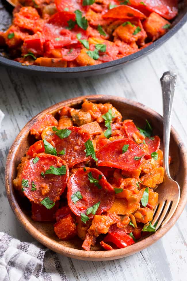 This sweet potato skillet is loaded up with all your favorite goodies just like a pepperoni pizza!  Pan-fried sweet potatoes with peppers, onions, mushrooms, pepperoni and pizza sauce make this paleo, gluten-free, dairy-free skillet quick, easy, and absolutely delicious!