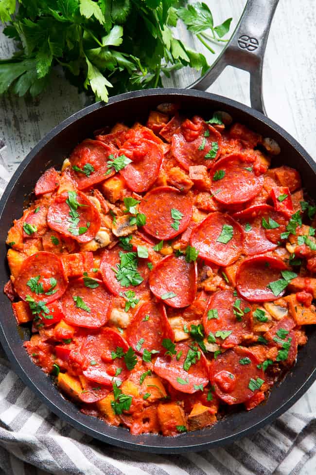 This sweet potato skillet is loaded up with all your favorite goodies just like a pepperoni pizza!  Pan-fried sweet potatoes with peppers, onions, mushrooms, pepperoni and pizza sauce make this paleo, gluten-free, dairy-free skillet quick, easy, and absolutely delicious!