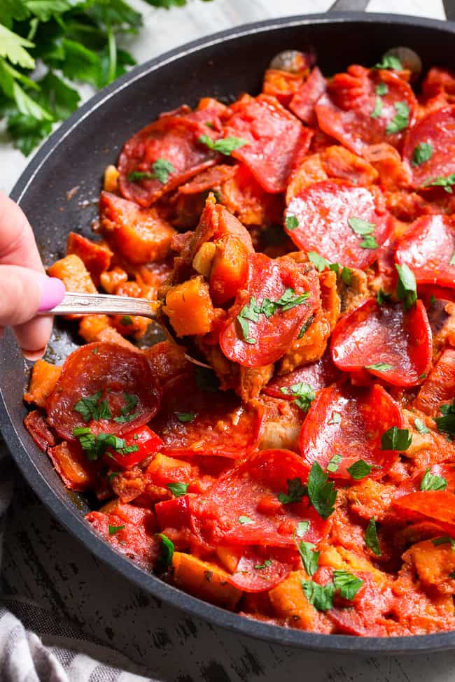 This sweet potato skillet is loaded up with all your favorite goodies just like a pepperoni pizza!  Pan-fried sweet potatoes with peppers, onions, mushrooms, pepperoni and pizza sauce make this paleo, gluten-free, dairy-free skillet quick, easy, and absolutely delicious!
