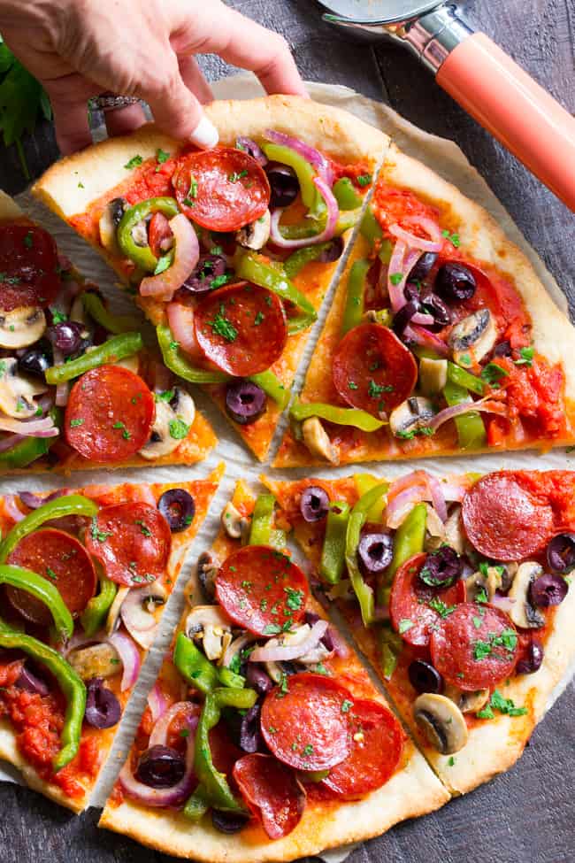 This paleo pepperoni pizza is loaded with all your favorite veggies and packed with flavor!  It's baked on the perfect paleo pizza crust and is totally dairy free, gluten free, grain free and soy free.  This healthy pizza is family approved and easy to make, too! 